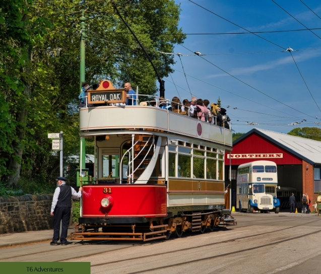 Family riding vintage trams at Crich Tramway Village in Derbyshire